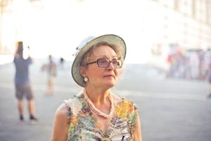 Elegant senior woman in Florence, Italy, enjoying a sunny day.
